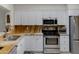 Well-lit kitchen featuring stainless steel appliances, granite countertops, and white cabinetry at 12809 N 50Th St, Scottsdale, AZ 85254