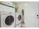 Functional laundry room featuring a full-sized washer, dryer, and ample storage space at 12809 N 50Th St, Scottsdale, AZ 85254