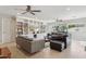 Spacious living room featuring built-in shelving, large windows, and comfortable leather seating at 12809 N 50Th St, Scottsdale, AZ 85254