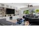 Comfortable living room featuring built-in cabinets, a ceiling fan, and natural light from the window at 12809 N 50Th St, Scottsdale, AZ 85254
