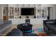 Well-lit living room featuring built-in shelves, a mounted TV, and comfortable seating at 12809 N 50Th St, Scottsdale, AZ 85254
