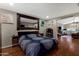 The primary bedroom has hardwood floors, a large mirror, a wood accent wall, and neutral paint at 12809 N 50Th St, Scottsdale, AZ 85254