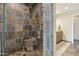 Modern shower with tile surround, seating, and glass door at 12809 N 50Th St, Scottsdale, AZ 85254