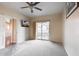 Bedroom with a ceiling fan, door to the hallway, and sliding glass door leading to a small balcony at 14575 W Mountain View Blvd # 925, Surprise, AZ 85374