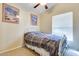 Bedroom with wall art, a white metal bed frame and a window at 14575 W Mountain View Blvd # 925, Surprise, AZ 85374