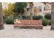 Well-maintained community entrance sign amidst lush landscaping and mature trees, creating an inviting atmosphere at 14575 W Mountain View Blvd # 925, Surprise, AZ 85374