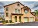 A two-story townhome with a private garage and light yellow stucco exterior and a red tile roof at 14575 W Mountain View Blvd # 925, Surprise, AZ 85374