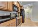 Kitchen featuring stainless steel appliances, granite countertops, wooden cabinetry and tile flooring at 14575 W Mountain View Blvd # 925, Surprise, AZ 85374