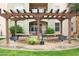 Inviting outdoor grilling area with picnic tables under a pergola, perfect for community gatherings at 14575 W Mountain View Blvd # 925, Surprise, AZ 85374