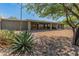 Backyard featuring desert landscaping, a covered patio, and a sliding glass door wall at 15602 N 56Th Pl, Scottsdale, AZ 85254