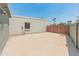 Backyard showcasing stucco walls, a modern slat fence, and a concrete slab at 15602 N 56Th Pl, Scottsdale, AZ 85254