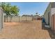 View of the backyard with gravel landscaping, mature trees, and block wall fencing at 15602 N 56Th Pl, Scottsdale, AZ 85254
