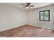 Empty bedroom featuring tile flooring and a window bringing in natural light at 15602 N 56Th Pl, Scottsdale, AZ 85254
