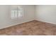 Empty bedroom with large window with shutter and tile floors at 15602 N 56Th Pl, Scottsdale, AZ 85254