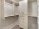 Walk-in closet featuring built-in storage with cabinets, drawers, and shelving at 15602 N 56Th Pl, Scottsdale, AZ 85254