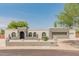 Charming single-story home with stucco facade, arched windows, desert landscaping, and a two-car garage at 15602 N 56Th Pl, Scottsdale, AZ 85254