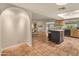 Bright kitchen featuring tile floors, wood cabinets, and an island with bar stool seating at 15602 N 56Th Pl, Scottsdale, AZ 85254