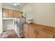 Well-organized laundry room boasts ample storage space with cabinets and shelving for efficient laundry tasks at 15602 N 56Th Pl, Scottsdale, AZ 85254