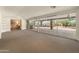 Spacious living room features large windows with a serene backyard view and ample natural light at 15602 N 56Th Pl, Scottsdale, AZ 85254