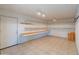 Interior shot of the storage room with built-in shelves and a tile floor at 15602 N 56Th Pl, Scottsdale, AZ 85254