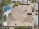 Birds eye view of a luxury home with a manicured roof, pool, and putting green at 16706 N 109Th Way, Scottsdale, AZ 85255