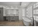 Elegant bathroom with vanity, free-standing tub, and privacy glass block window at 16706 N 109Th Way, Scottsdale, AZ 85255