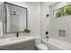Modern bathroom featuring a tub-shower combination and a stylish vanity with a leafy plant at 16706 N 109Th Way, Scottsdale, AZ 85255