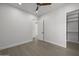 Bedroom with hardwood floors, modern fan, and walk-in closet with wire shelving at 16706 N 109Th Way, Scottsdale, AZ 85255