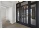 Modern entryway featuring a dark paneled glass front door with views of the exterior at 16706 N 109Th Way, Scottsdale, AZ 85255