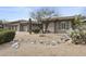 A home with a three car garage, with landscaping featuring native plants and a rock feature at 16706 N 109Th Way, Scottsdale, AZ 85255