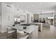 Open kitchen with dual islands, stainless steel appliances, and a seamless connection to the living area with fireplace at 16706 N 109Th Way, Scottsdale, AZ 85255