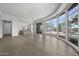 Open concept living area featuring wood floors and large curved windows with pool views at 16706 N 109Th Way, Scottsdale, AZ 85255