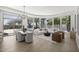 Open-concept living room featuring expansive windows, a modern chandelier, and views of the pool at 16706 N 109Th Way, Scottsdale, AZ 85255