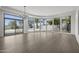 Modern living room featuring hardwood floors, curved windows, and natural light at 16706 N 109Th Way, Scottsdale, AZ 85255