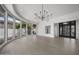 Bright living room boasts curved windows, modern chandelier, and hardwood floors at 16706 N 109Th Way, Scottsdale, AZ 85255