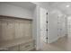 Mudroom with convenient seating, storage, and open door to living spaces at 16706 N 109Th Way, Scottsdale, AZ 85255