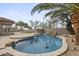 Inviting pool featuring a unique design, rock waterfall, and lush desert landscaping at 16706 N 109Th Way, Scottsdale, AZ 85255