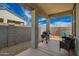 Covered patio perfect for outdoor dining, with a grill and furniture in a well-maintained backyard space at 17308 W Daley Ln, Surprise, AZ 85387