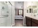 Main bathroom view showcasing the shower and access to the main bedroom at 17308 W Daley Ln, Surprise, AZ 85387