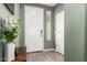 Welcoming entryway with a white front door, neutral wall color, and stylish wood-look tile flooring at 17308 W Daley Ln, Surprise, AZ 85387