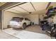 Organized garage with parking space, storage racks, and ample room for vehicles and equipment at 17308 W Daley Ln, Surprise, AZ 85387