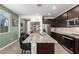 Spacious kitchen featuring dark cabinets, stainless steel appliances, an island, and a pantry at 17308 W Daley Ln, Surprise, AZ 85387