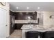 Kitchen with stainless steel appliances, granite countertops, a subway tile backsplash, and dark cabinetry at 17308 W Daley Ln, Surprise, AZ 85387