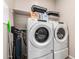 Well-equipped laundry room with modern appliances, shelving, and storage solutions for efficient organization and convenience at 17308 W Daley Ln, Surprise, AZ 85387