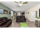 Inviting living room with neutral paint, ceiling fan, and wood-look tile flooring at 17308 W Daley Ln, Surprise, AZ 85387