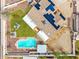 Aerial view of a property with a pool, green lawn, solar panels, and shaded patio at 18440 N 43Rd Dr, Glendale, AZ 85308