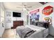 This bedroom features a ceiling fan, dark wood dresser, and decorative wall signage at 18440 N 43Rd Dr, Glendale, AZ 85308