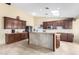 Spacious kitchen featuring granite countertops, dark cabinetry, and a functional center island at 18440 N 43Rd Dr, Glendale, AZ 85308