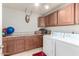 This laundry room has updated cabinets, granite countertops and appliances at 18440 N 43Rd Dr, Glendale, AZ 85308