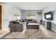 Comfortable living room with a plush grey sectional and a stylish area rug at 18440 N 43Rd Dr, Glendale, AZ 85308